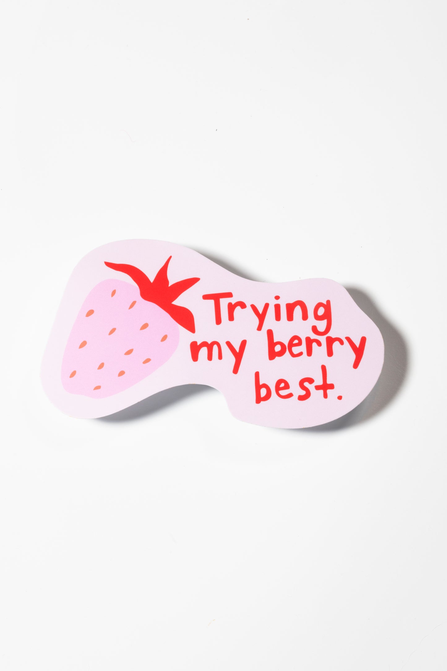 Sticker featuring a pink strawberry illustration and red text reading "Trying my berry best" on a plain white background.