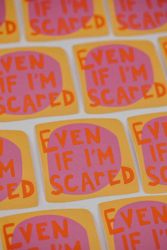 An image showing multiple square stickers with the text "Even if I'm scared" written in red letters on an orange background.