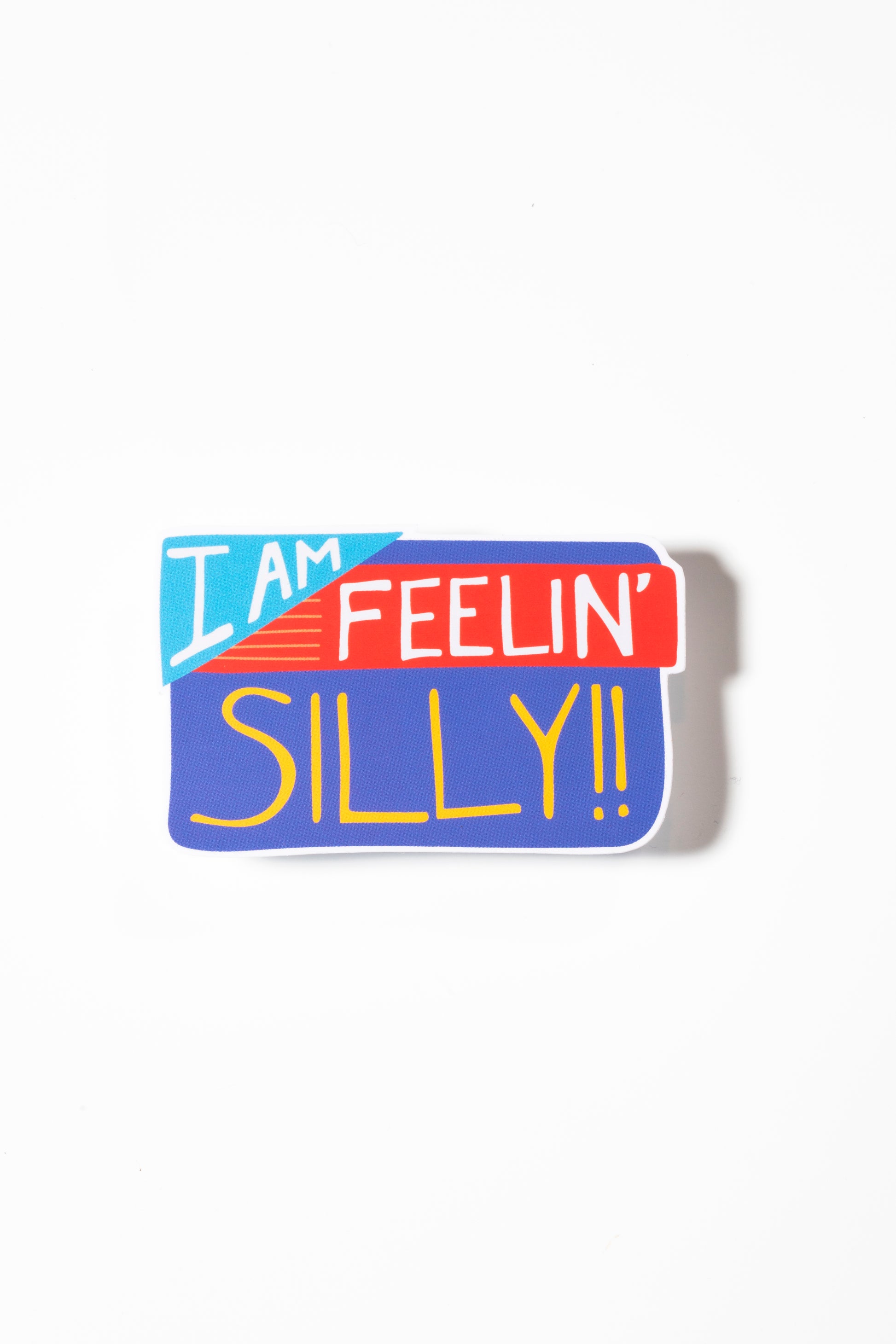 Sticker that reads "I am feelin' silly" in reds, blues, and yellows photographed on a white background.