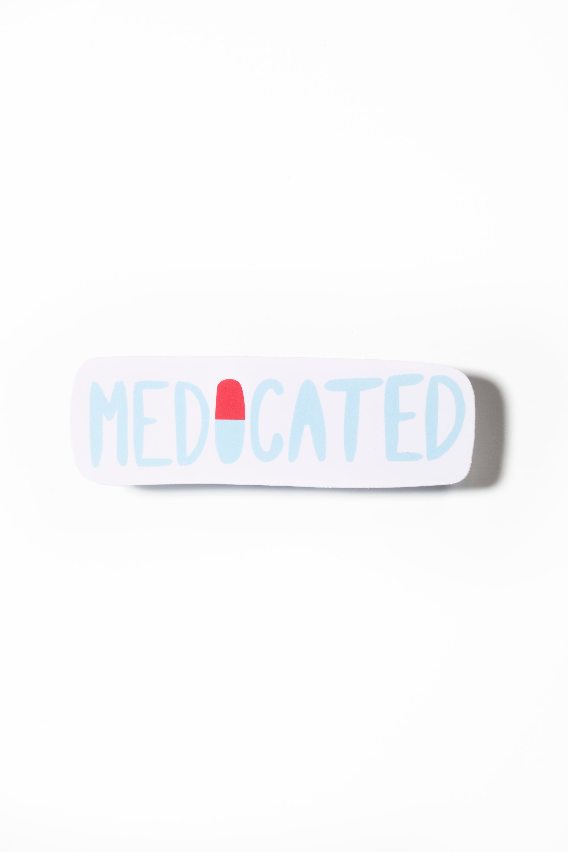 A white sticker with the text "MEDICATED" printed on it in blue and red lettering.