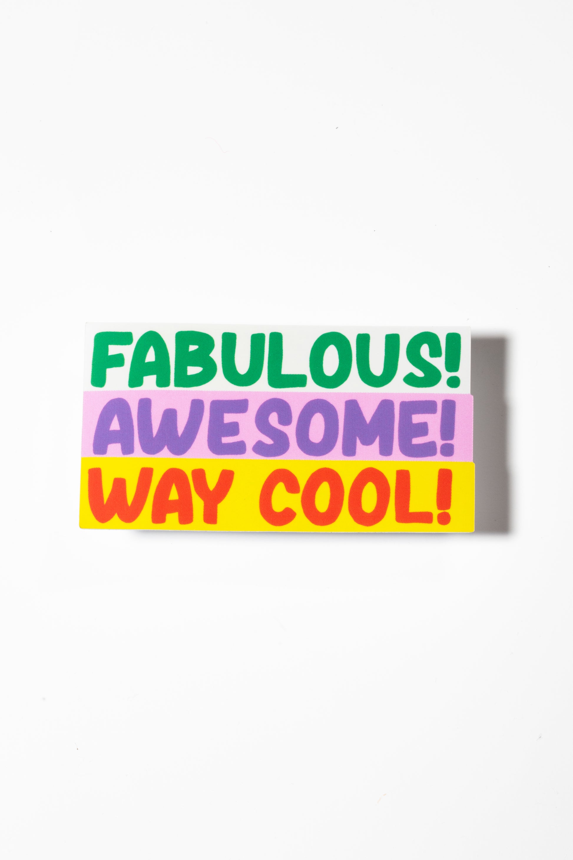 Sticker that reads "fabulous" in green, "awesome" in purple on pink, and "way cool" in red on yellow shot on a white background.